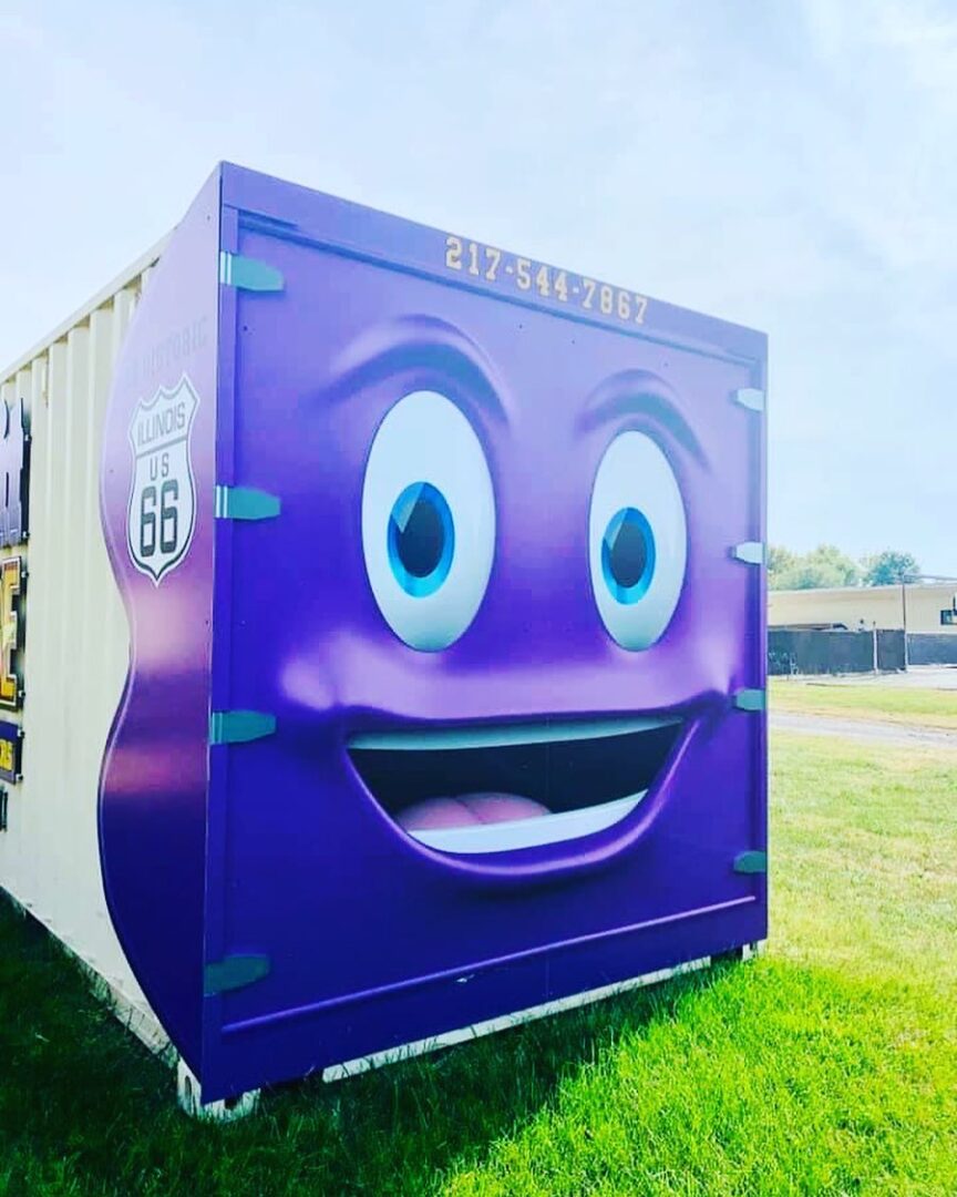 A purple container with a smiling face on it.
