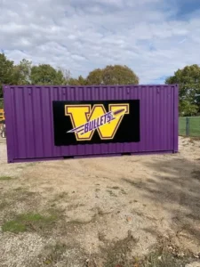 A purple shipping container with the name " wolves ".