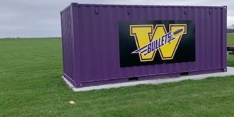 A purple container with the name " w " on it.